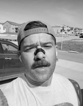 Instagram Athlete using SLYD Nasal Strips, the stickier version, on his nose.